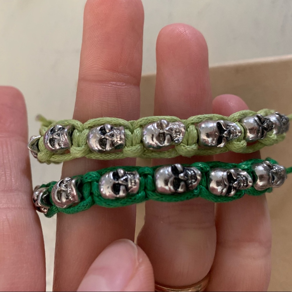Nwot set of 2 green & silver skull bracelets